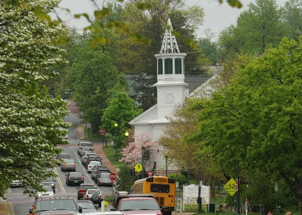 Historic church steeple on a tree-lined street in Vienna, Virginia