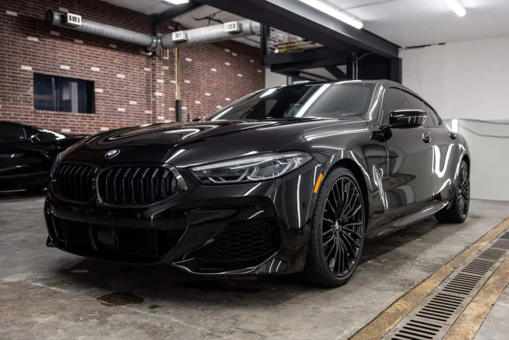 Black BMW 840i with a mirror-like finish