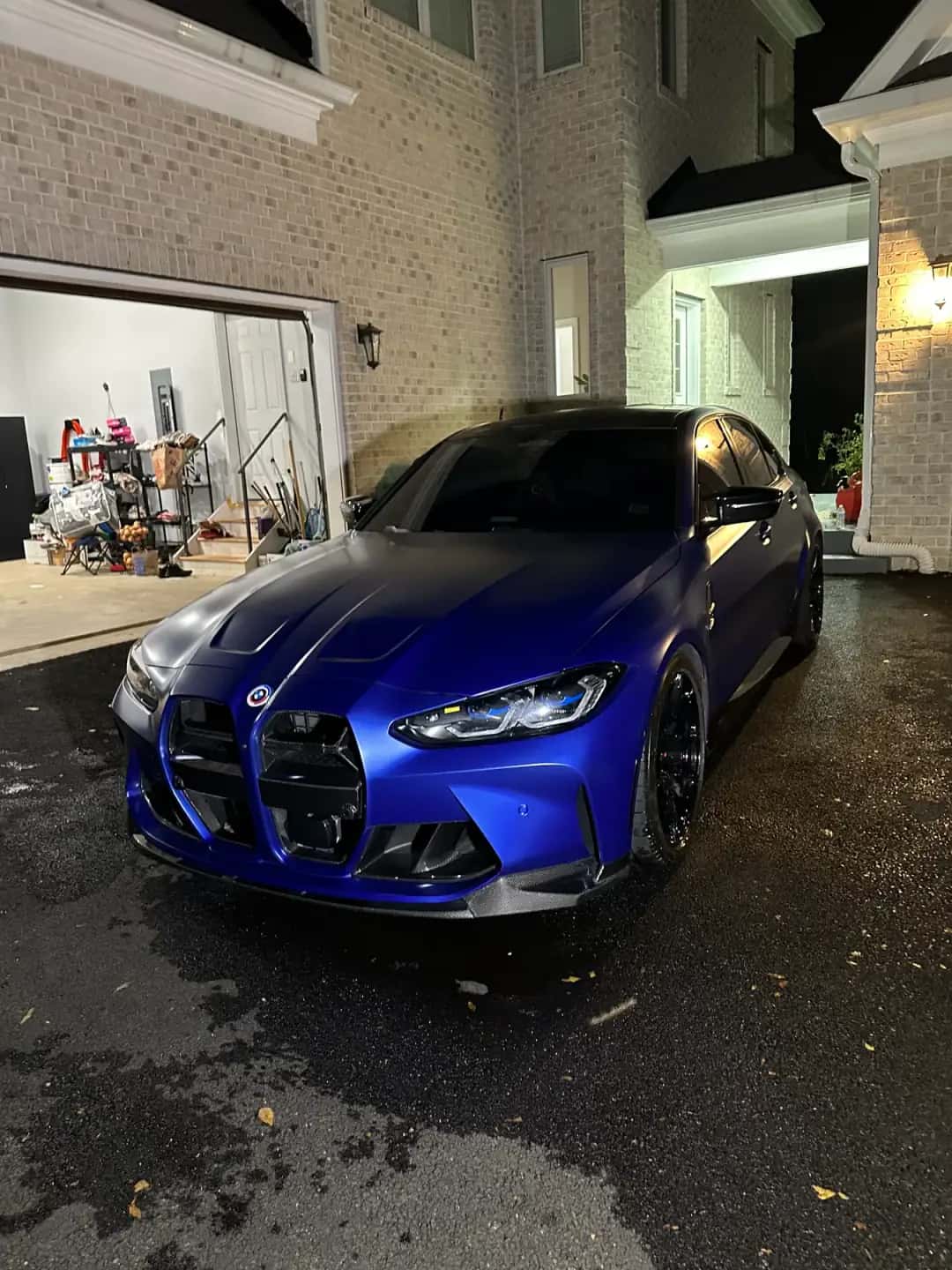 Blue BMW M4 with dark tinted windows in a Fairfax, VA driveway