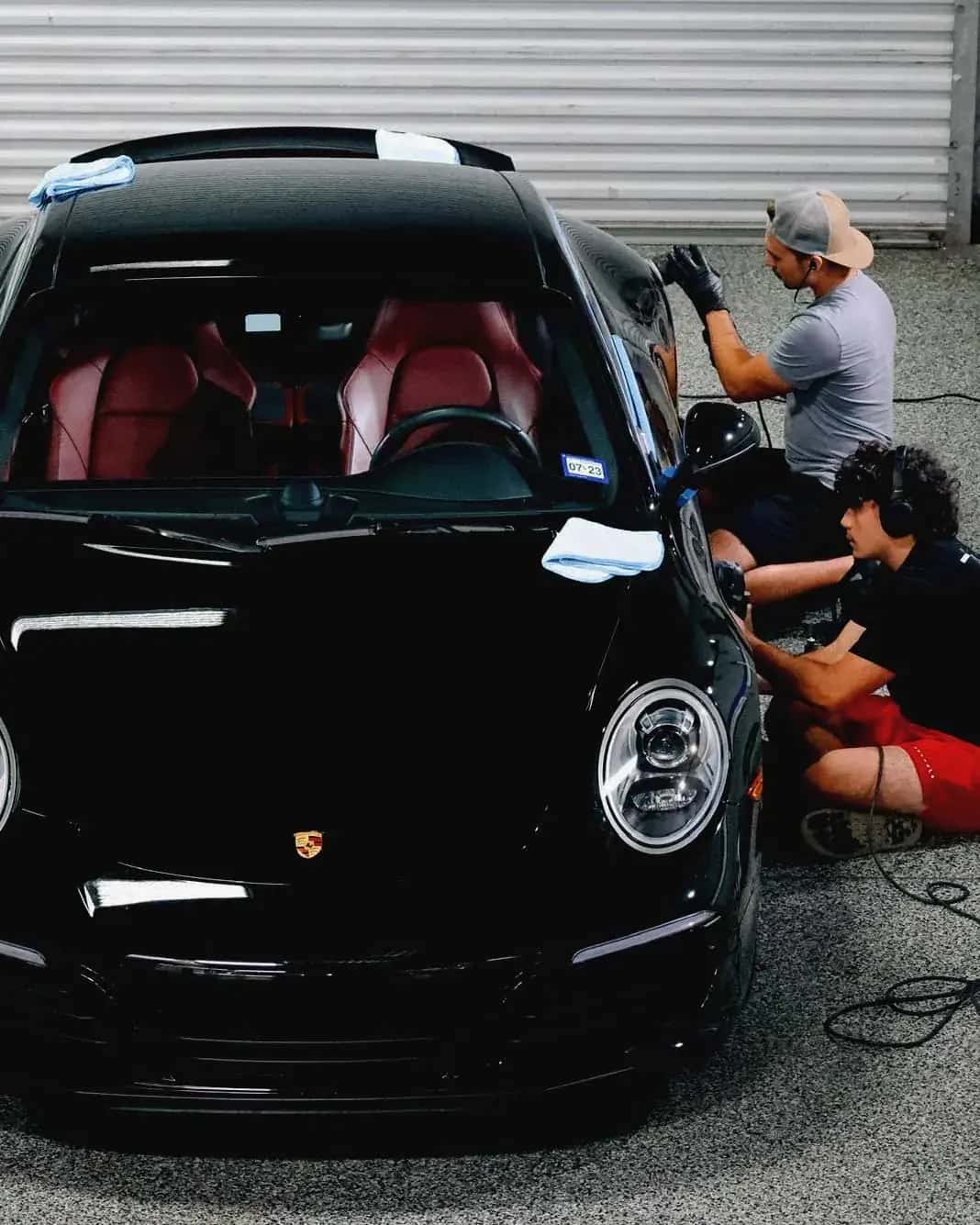 Fairfax Shine detailers hand-finishing a black Porsche 911 in Northern Virginia